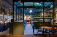 a restaurant with tables and chairs and plants at Stayokay Hostel Amsterdam Vondelpark in Amsterdam