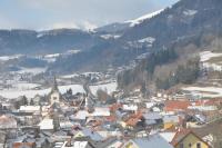 a town with snow covered roofs and a mountain at Pension Geissler-Reicher in Oberwölz Stadt