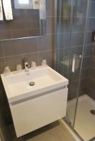 a bathroom with a white sink and a shower at Hotel Bleu Azur in Argelès-sur-Mer