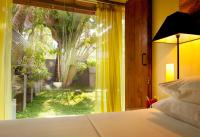 a bedroom with a bed and a large window at Dickman Resort "The Boutique Hotel" in Negombo