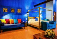 a bedroom with a bed and a bed and a couch at Dickman Resort "The Boutique Hotel" in Negombo