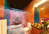 a bathroom with a toilet and a bath tub at Dickman Resort "The Boutique Hotel" in Negombo