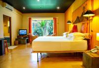 a bedroom with a large bed and a television at Dickman Resort "The Boutique Hotel" in Negombo