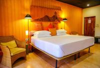 a bedroom with a large bed and a chair at Dickman Resort "The Boutique Hotel" in Negombo