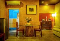 a room with a table with chairs and a tree stump at Dickman Resort "The Boutique Hotel" in Negombo