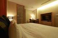a bedroom with a bed and a flat screen tv at Jingan Classic Inn in Zhonghe