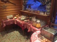 a table with food on it in a room at Hôtel Le Dôme in L&#39;Alpe-d&#39;Huez