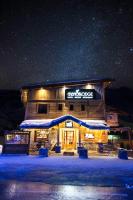a building with a sign that reads guest house at night at Chamois Lodge in Les Deux Alpes