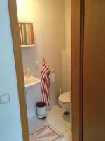 a small bathroom with a toilet and a sink at Pension Freund in Rothenburg ob der Tauber