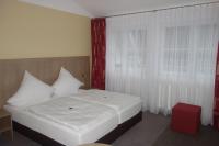 a bedroom with a white bed and a red window at Haus Dumicketal in Drolshagen