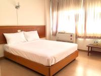 Ein Bett oder Betten in einem Zimmer der Unterkunft Srivichai Hotel