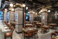 a restaurant with tables and chairs in a room at Hotel Theodore Seattle Downtown, Tapestry by Hilton in Seattle