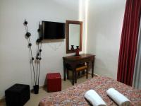 a bedroom with a bed and a desk and a mirror at Hotel Las Canteras de Puerto Real in Puerto Real