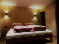 a bed in a room with lights on the wall at Chalet Auszeit in Arzl im Pitztal
