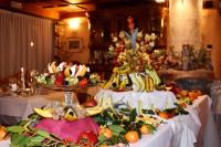 a table with two cakes and fruit on it at Le Rocher Hotel in Champoluc