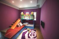 a childs room with purple walls and a bunk bed at Sharjah B&amp;B in Wujie
