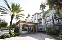 a building with palm trees in front of it at Trianon Bonita Bay Hotel in Bonita Springs