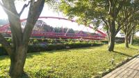 a red roller coaster in a park with trees at Rainbow Bridge B&amp;B in Sanzhi