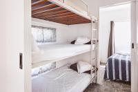 a bedroom with two bunk beds and a bed at Lorne Foreshore Caravan Park in Lorne