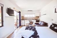 a bedroom with a bed and a living room at Lorne Foreshore Caravan Park in Lorne