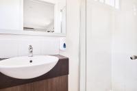 a bathroom with a sink and a shower at Lorne Foreshore Caravan Park in Lorne