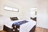 a bedroom with a large bed and a window at Lorne Foreshore Caravan Park in Lorne