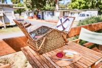 a picnic table with a picnic basket on top of it at Lorne Foreshore Caravan Park in Lorne