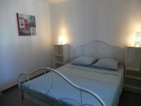 a small bedroom with two beds and two lamps at Mas Vincent in La Fare-les-Oliviers