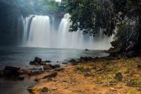 a waterfall in front of a body of water at New Center Hotel in Carolina