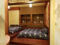 a bedroom with a bed and a book shelf at Beautifl Sweet Warm B&amp;B in Hualien City