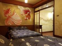 a bedroom with a bed and a painting on the wall at Beautifl Sweet Warm B&amp;B in Hualien City