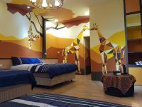 a bedroom with two beds and a mural of giraffes at Beautifl Sweet Warm B&amp;B in Hualien City