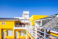 a group of buildings with yellow and white at Summer Ya B&amp;B in Huxi