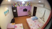 a room with a bedroom with a bed and a tv at 龍園旅館Long Yuan Hotel in Budai