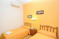 A bed or beds in a room at Hostal Edreira