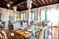 Un comedor con mesa y sillas de madera. en Hotel Oromana, en Alcalá de Guadaira