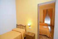 A bed or beds in a room at Hostal Edreira