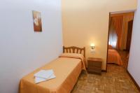 A bed or beds in a room at Hostal Edreira