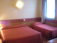 Posteľ alebo postele v izbe v ubytovaní Hotel Roma