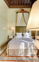 a bedroom with a large bed with a canopy at Sacristia de Santa Ana in Seville