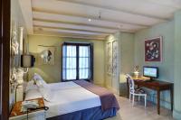 a bedroom with a bed and a desk with a computer at Sacristia de Santa Ana in Seville
