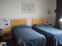 Posteľ alebo postele v izbe v ubytovaní Hotel Roma