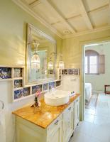 a bathroom with a sink and a mirror at Sacristia de Santa Ana in Seville