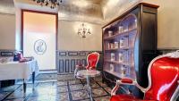 a dining room with a red chair and a table at Sacristia de Santa Ana in Seville