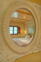 a bedroom with a mirror on the wall at Sacristia de Santa Ana in Seville