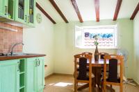 a kitchen with a table and chairs and a window at Stipica Apartment in Lumbarda