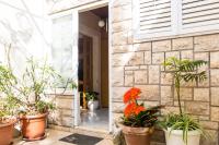 a group of potted plants on the side of a building at Stipica Apartment in Lumbarda