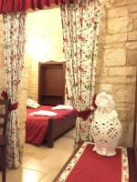 Posteľ alebo postele v izbe v ubytovaní Trulli e Puglia Resort