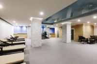 a lobby with chairs and tables in a building at Renion Park Hotel in Almaty