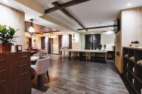 a large room with a salon with a table and chairs at Renion Park Hotel in Almaty